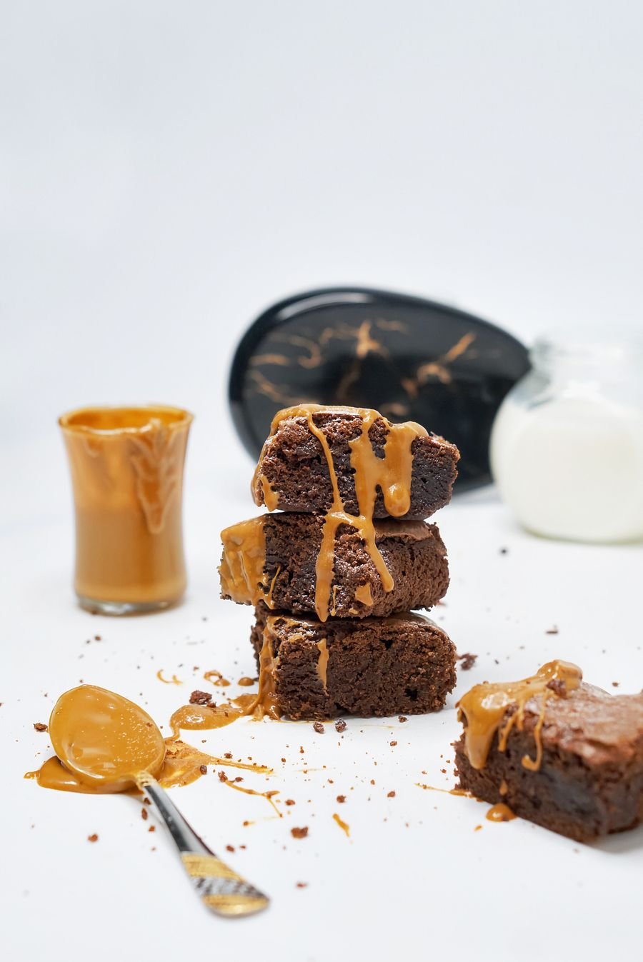 Stacked brownies with caramel running down the sides