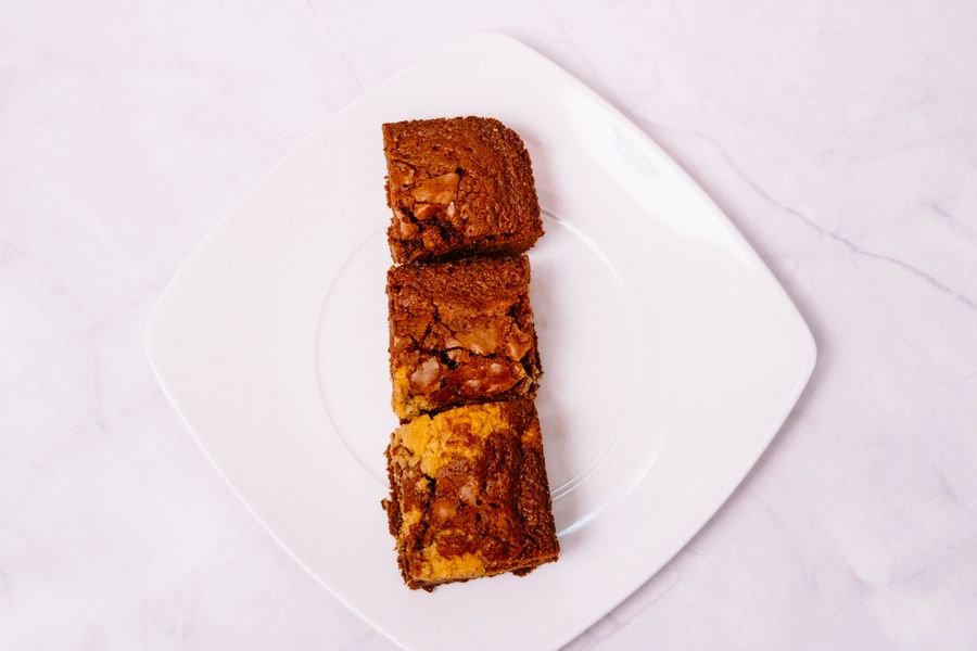 Golden blondie squares on a white plate